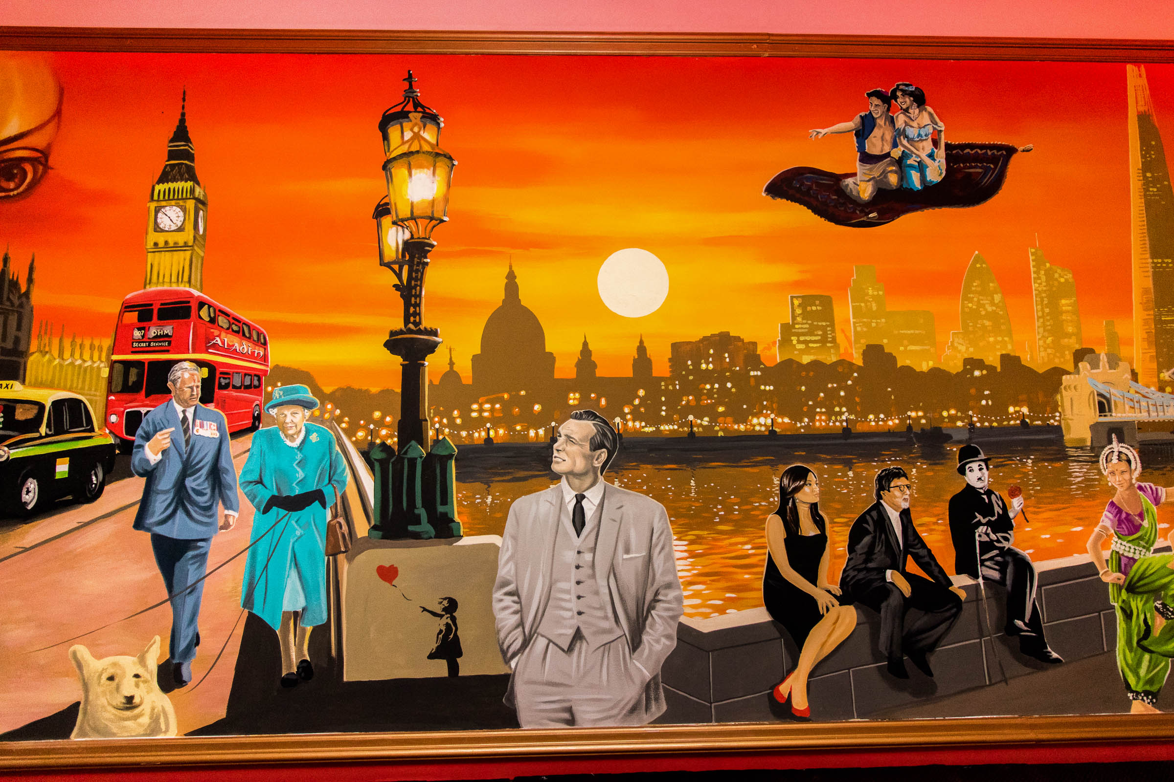 Mural of the London skyline, Westminster Bridge street lamps, Aladin and Jasmin, Charlie Chaplin beside Bollywood stars Amitabh Bachchan and Aishwarya Rai Bachchan