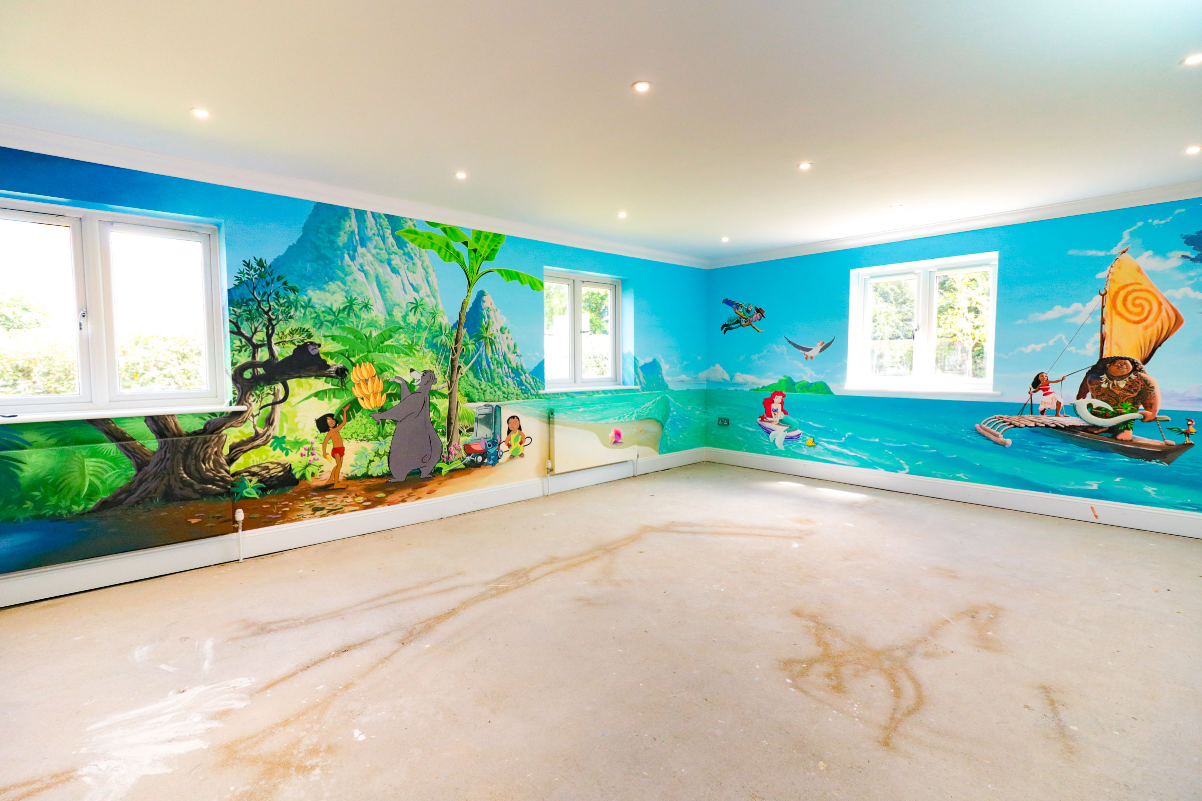 playroom mural, featuring Jungle book characters Mowgli Bagheera and Baloo, plus Lilo and Stitch, the Little Mermaid, Woody and Buzz Lightyear and more details in an expansive Moana backdrop