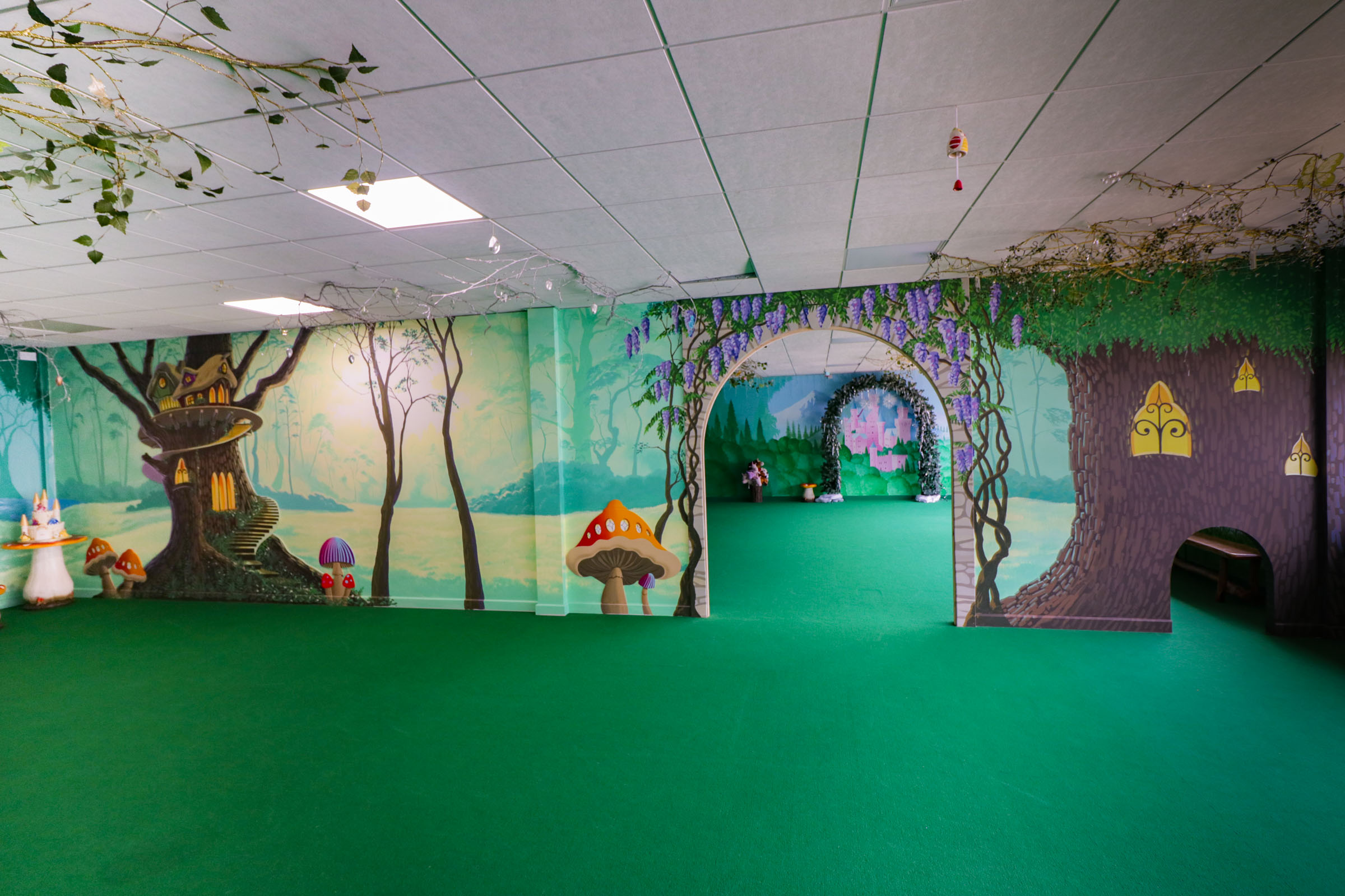 Magic Forest Party Room at the Riverside Hub, Northampton,view from one party room to the next through the wisteria covered arch featuring the misty glowing sunset through the forest.