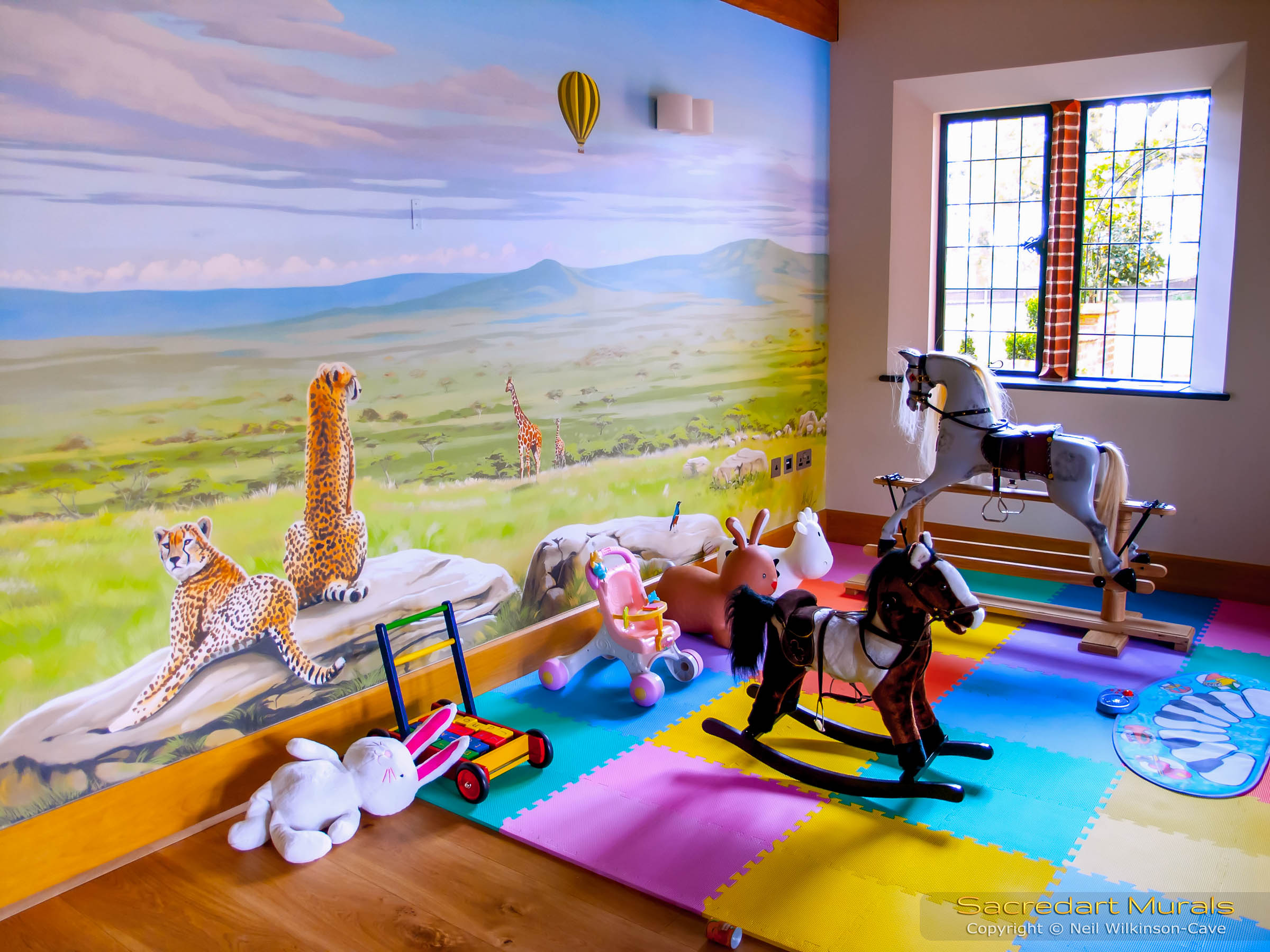 Rocking horses and safari mural